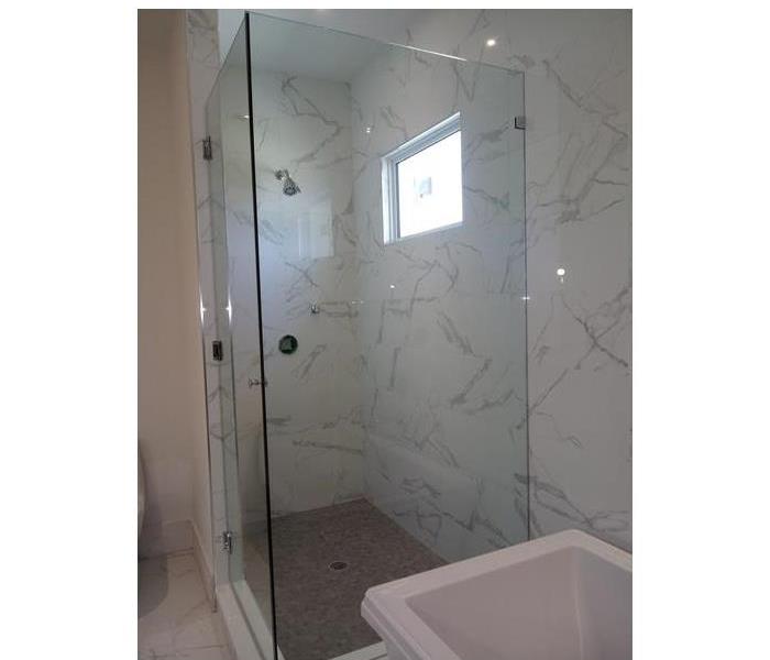 glass shower in white bathroom